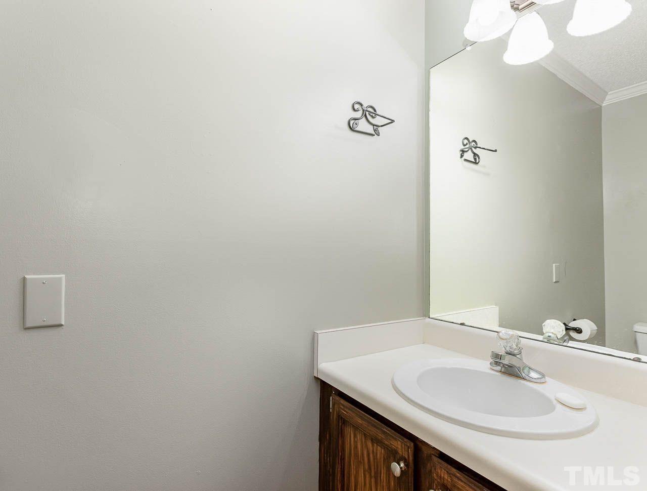 2512 Holbrook Court Raleigh, NC 27604 - Photo 15 of 26 a bathroom with a sink vanity and a mirror