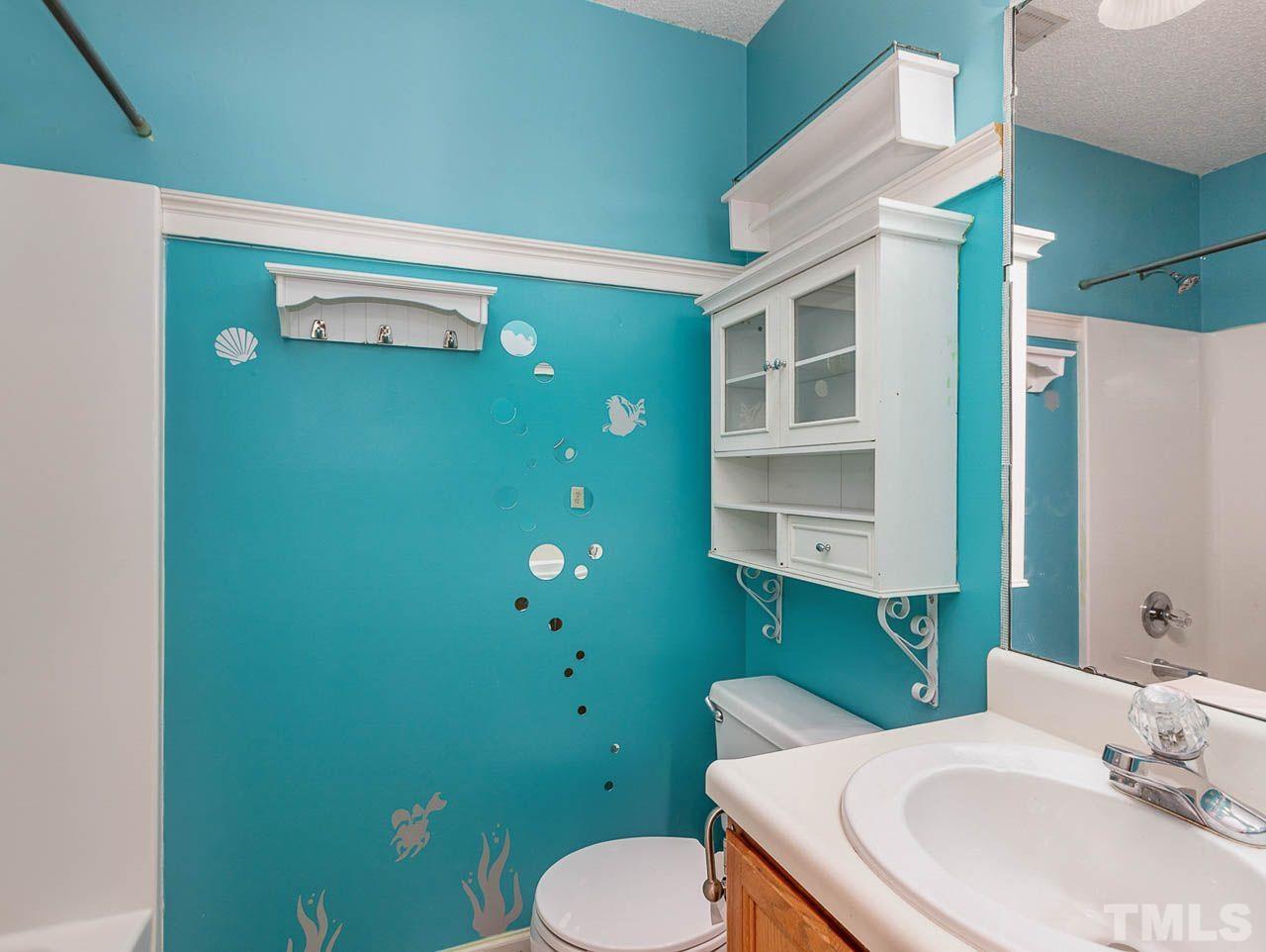 2512 Holbrook Court Raleigh, NC 27604 - Photo 16 of 26 a bathroom with a sink a toilet and mirror