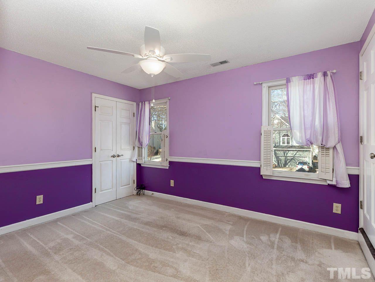 2512 Holbrook Court Raleigh, NC 27604 - Photo 17 of 26 a spacious bedroom with a bed and a chandelier