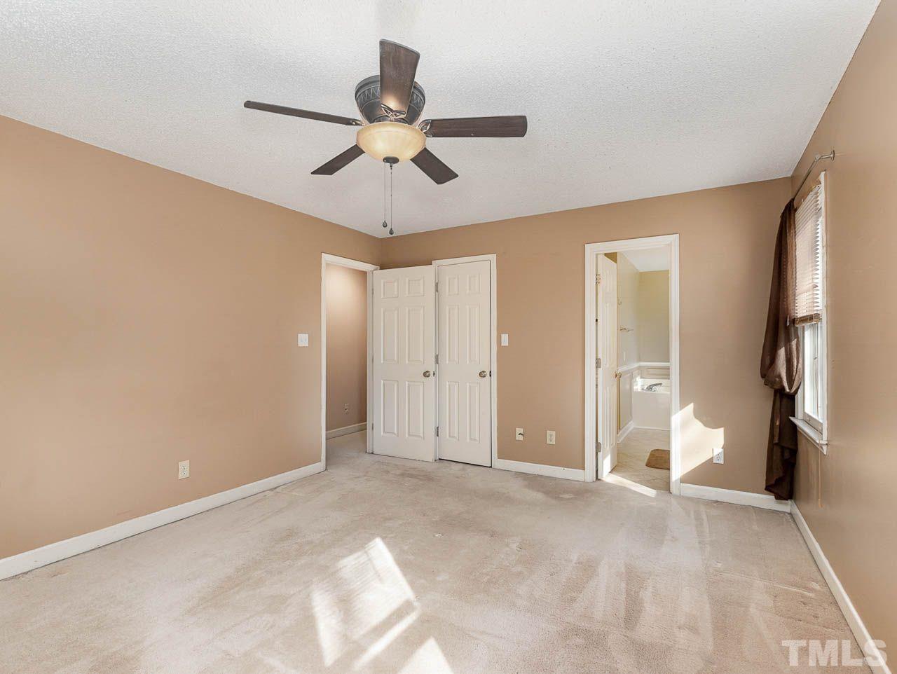 2512 Holbrook Court Raleigh, NC 27604 - Photo 24 of 26 a view of an empty room with a chandelier fan