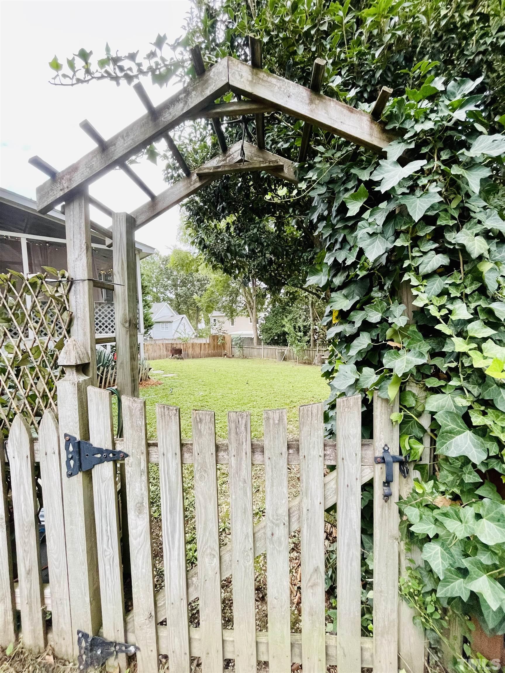 2512 Holbrook Court Raleigh, NC 27604 - Photo 4 of 26 a view of a wooden fence and a tree