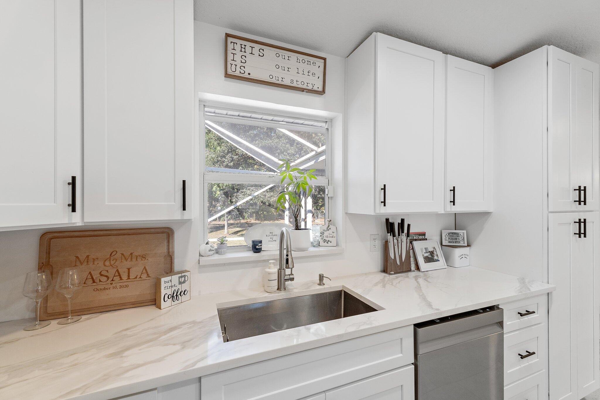 18389 41st Road North Loxahatchee, FL 33470 - Photo 12 of 33 a kitchen with stainless steel appliances granite countertop a sink and a white cabinets