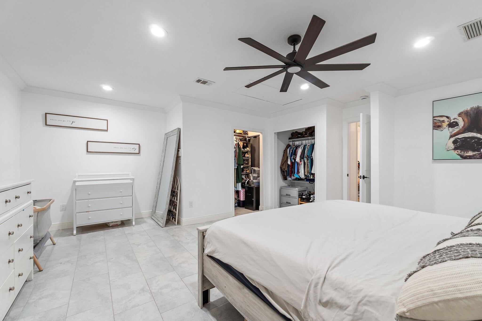 18389 41st Road North Loxahatchee, FL 33470 - Photo 14 of 33 a room with a bed and a ceiling fan