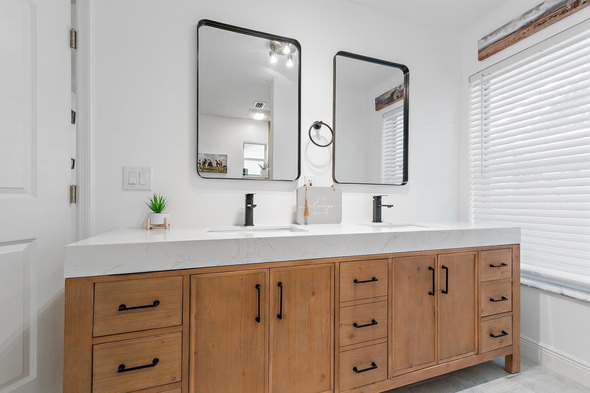 18389 41st Road North Loxahatchee, FL 33470 - Photo 17 of 33 a bathroom with a double vanity sink and mirror