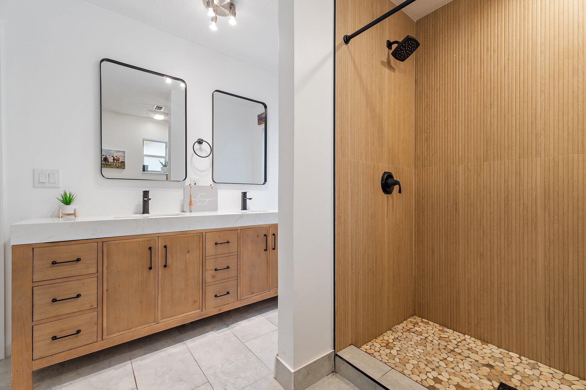 18389 41st Road North Loxahatchee, FL 33470 - Photo 18 of 33 a spacious bathroom with a double vanity sink a large mirror a shower and a bathtub