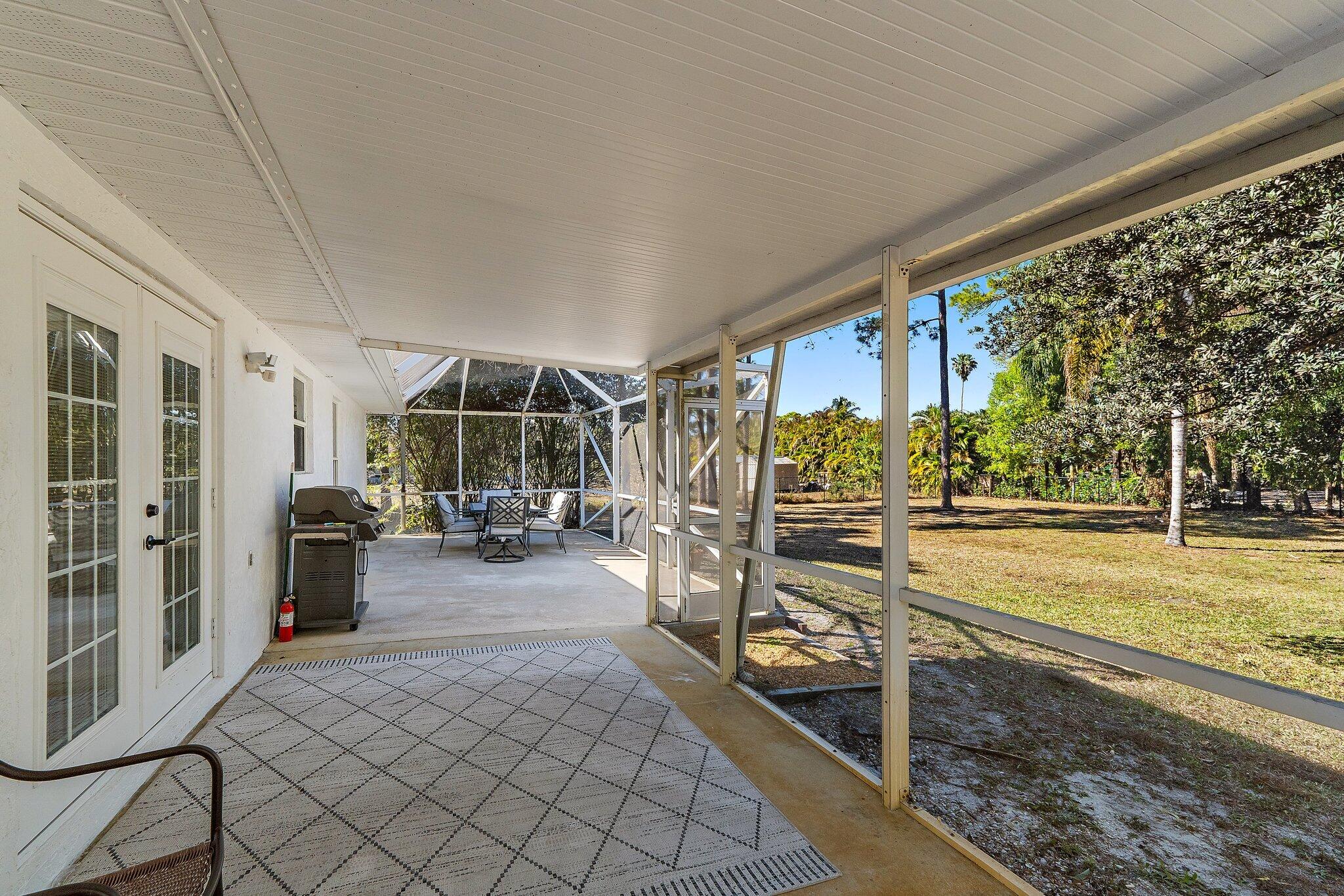 18389 41st Road North Loxahatchee, FL 33470 - Photo 26 of 33 a view of a chairs and table in a patio