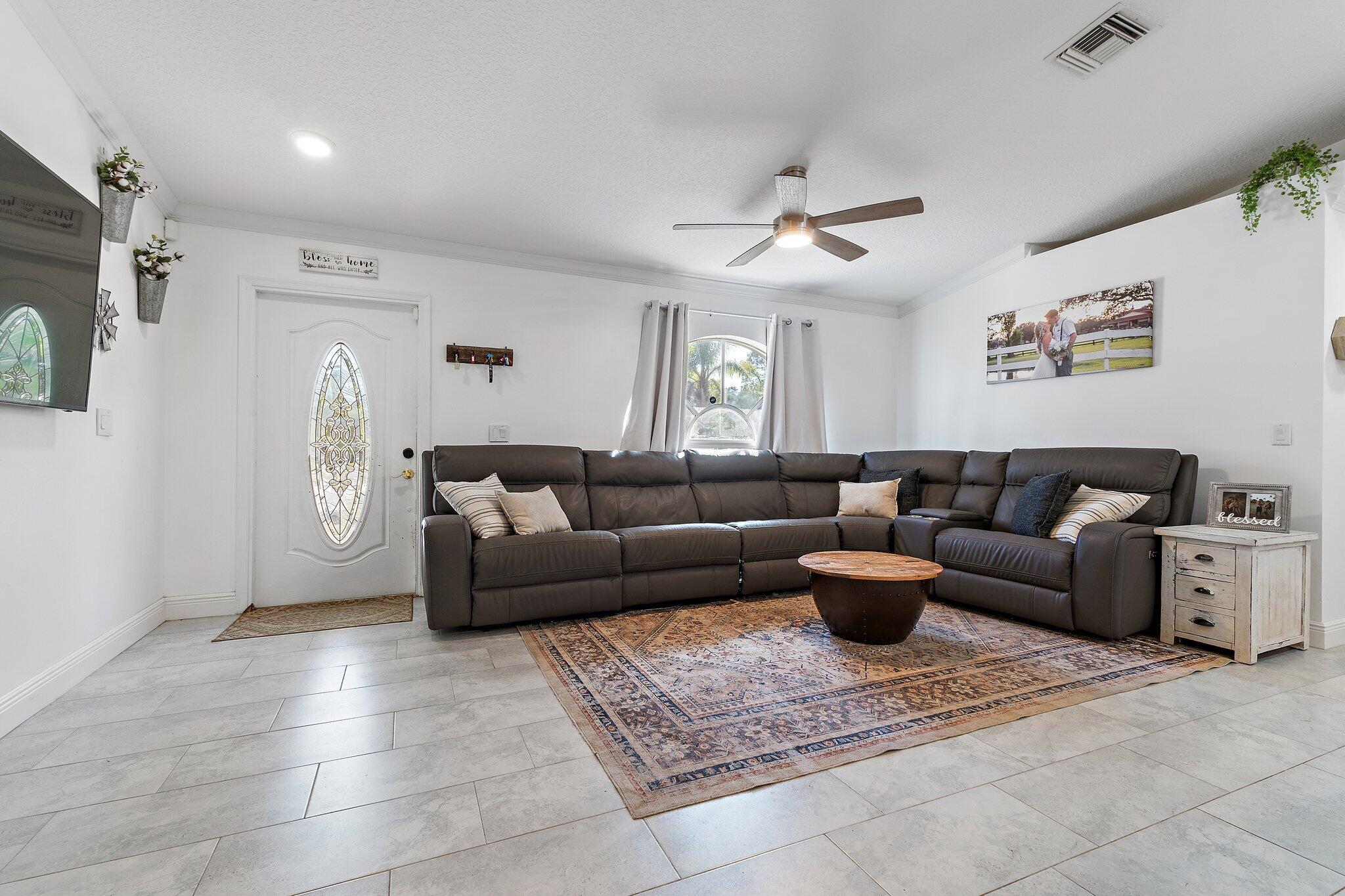 18389 41st Road North Loxahatchee, FL 33470 - Photo 5 of 33 a living room with furniture and a clock