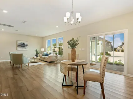 a view of a dining room with furniture wooden floor and chandelier