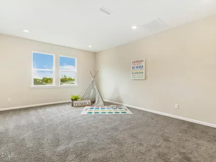 an empty room with windows and couch