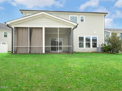 a front view of a house with a yard and trees