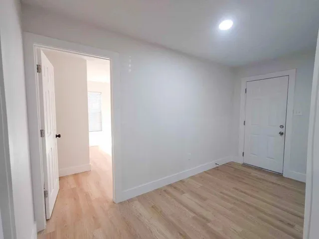a view of a room with wooden floor
