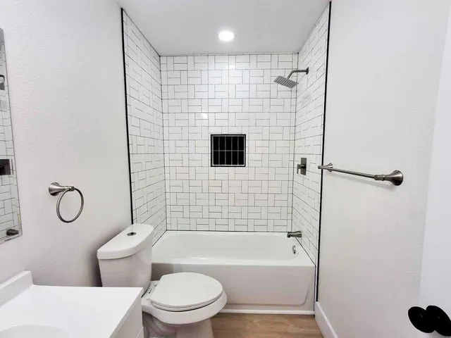 a bathroom with a toilet bathtub and shower