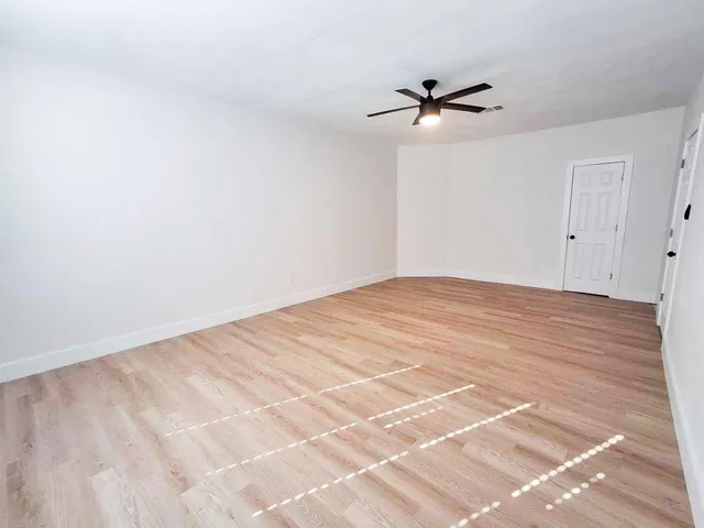 a view of a room with a ceiling fan