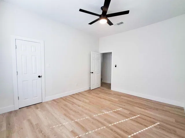 a view of a room with a ceiling fan