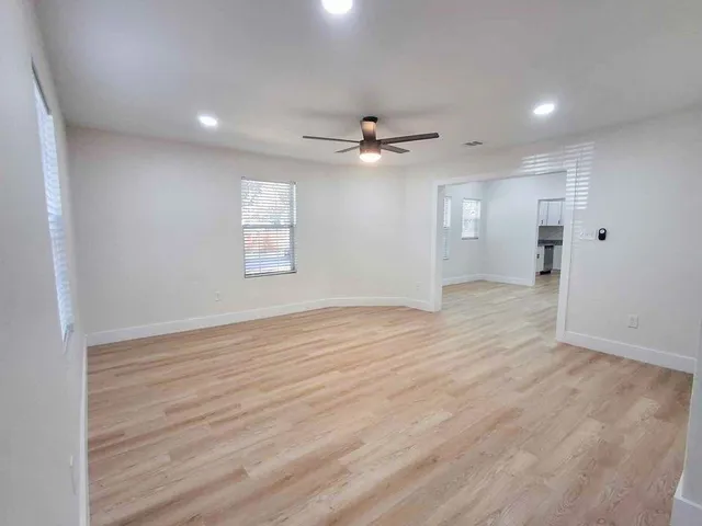 wooden floor in an empty room with a window