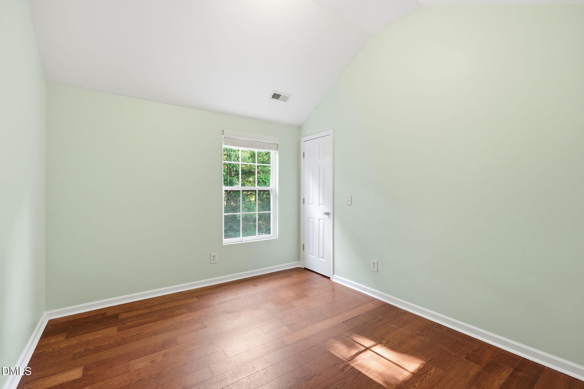 4232 Dalcross Road Raleigh, NC 27610 - Photo 23 of 42 an empty room with wooden floor and windows