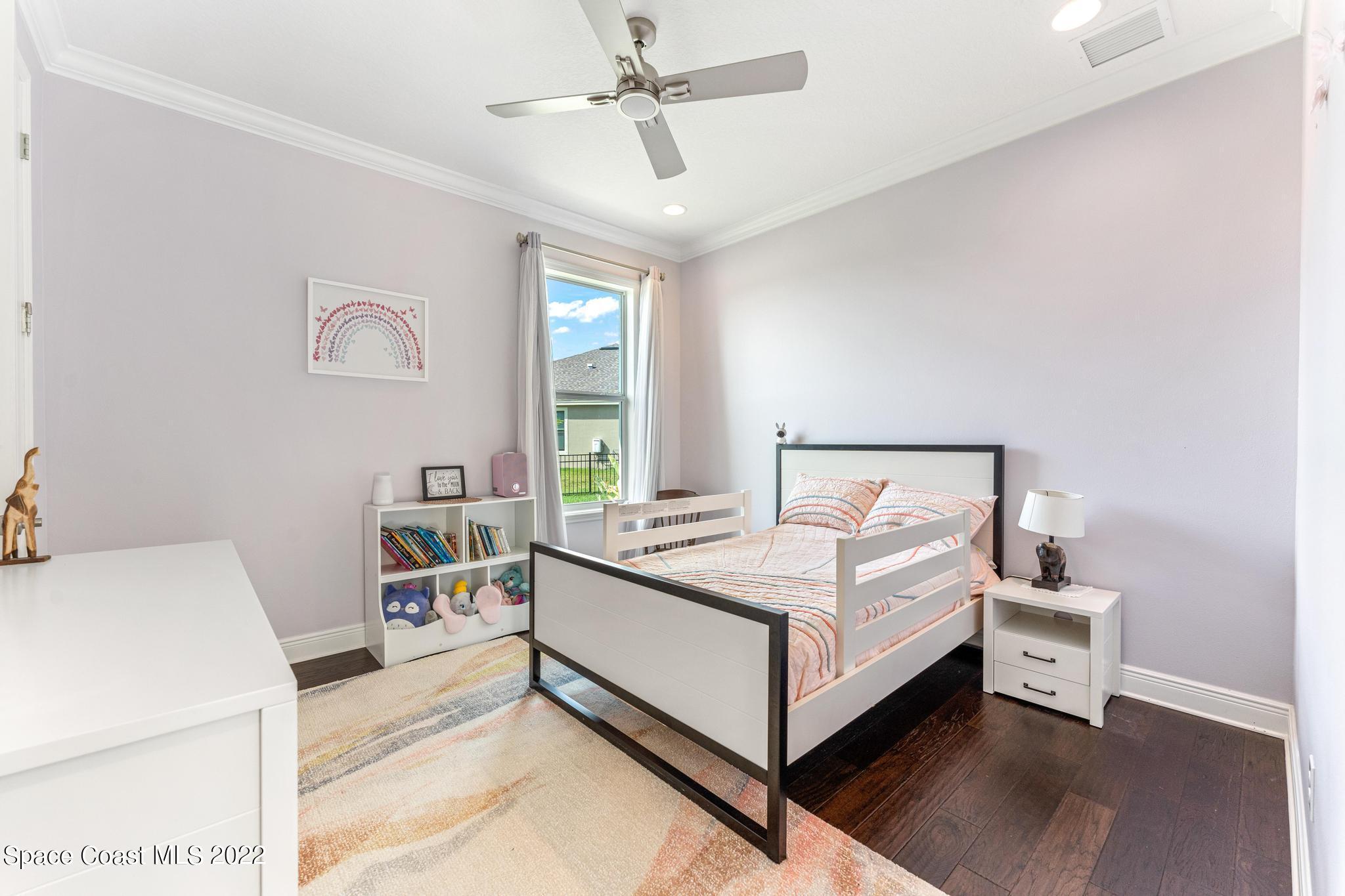 7739 Kerrington Drive Melbourne, FL 32940 - Photo 12 of 35 a bedroom with a bed and window