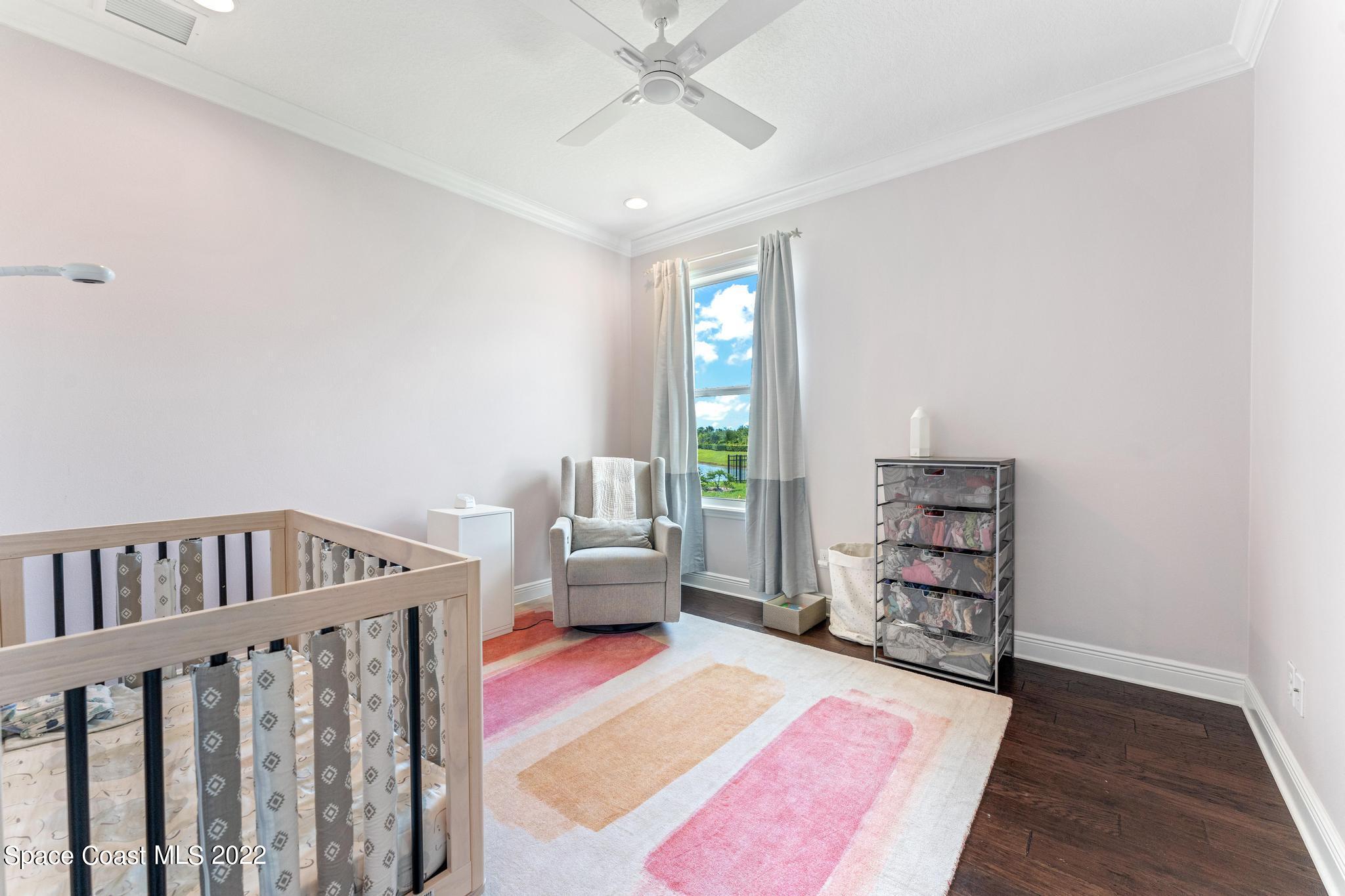 7739 Kerrington Drive Melbourne, FL 32940 - Photo 14 of 35 a living room with furniture and a book shelf