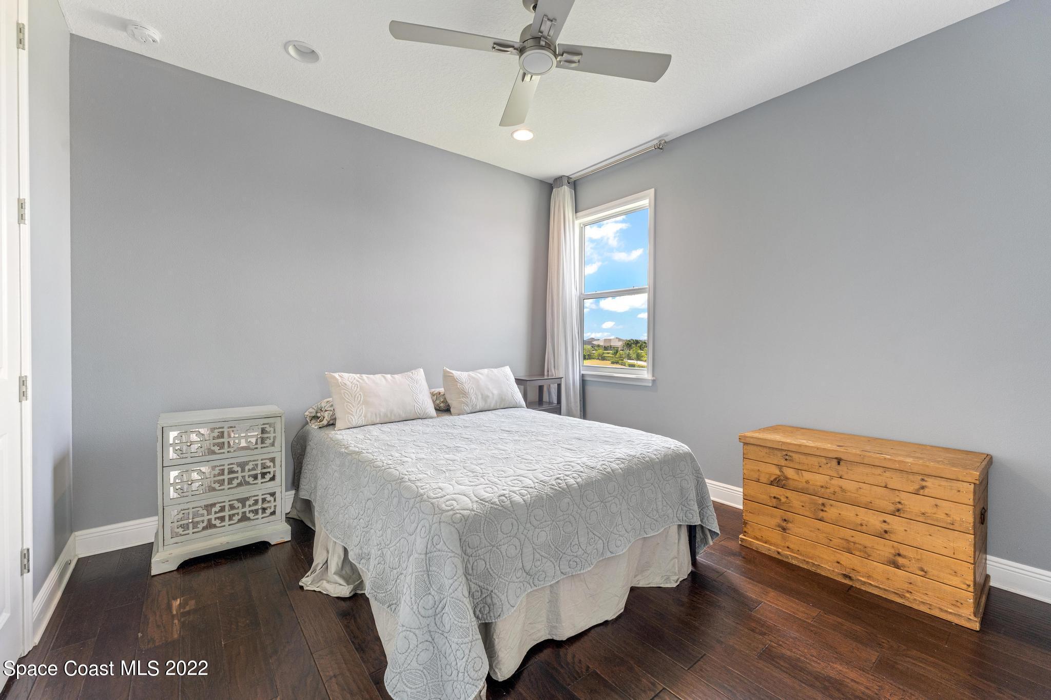 7739 Kerrington Drive Melbourne, FL 32940 - Photo 18 of 35 a bedroom with a bed and a window