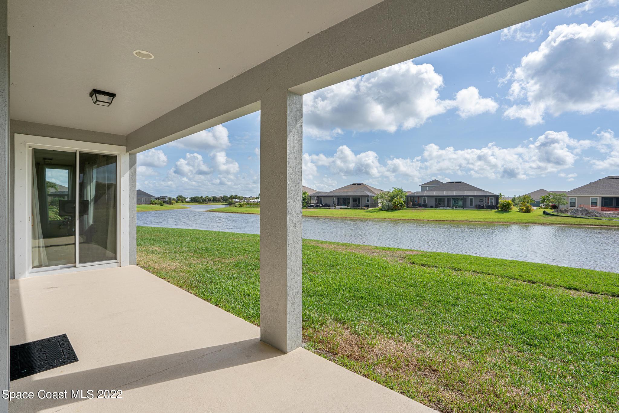 7739 Kerrington Drive Melbourne, FL 32940 - Photo 20 of 35 a view of a lake from a yard