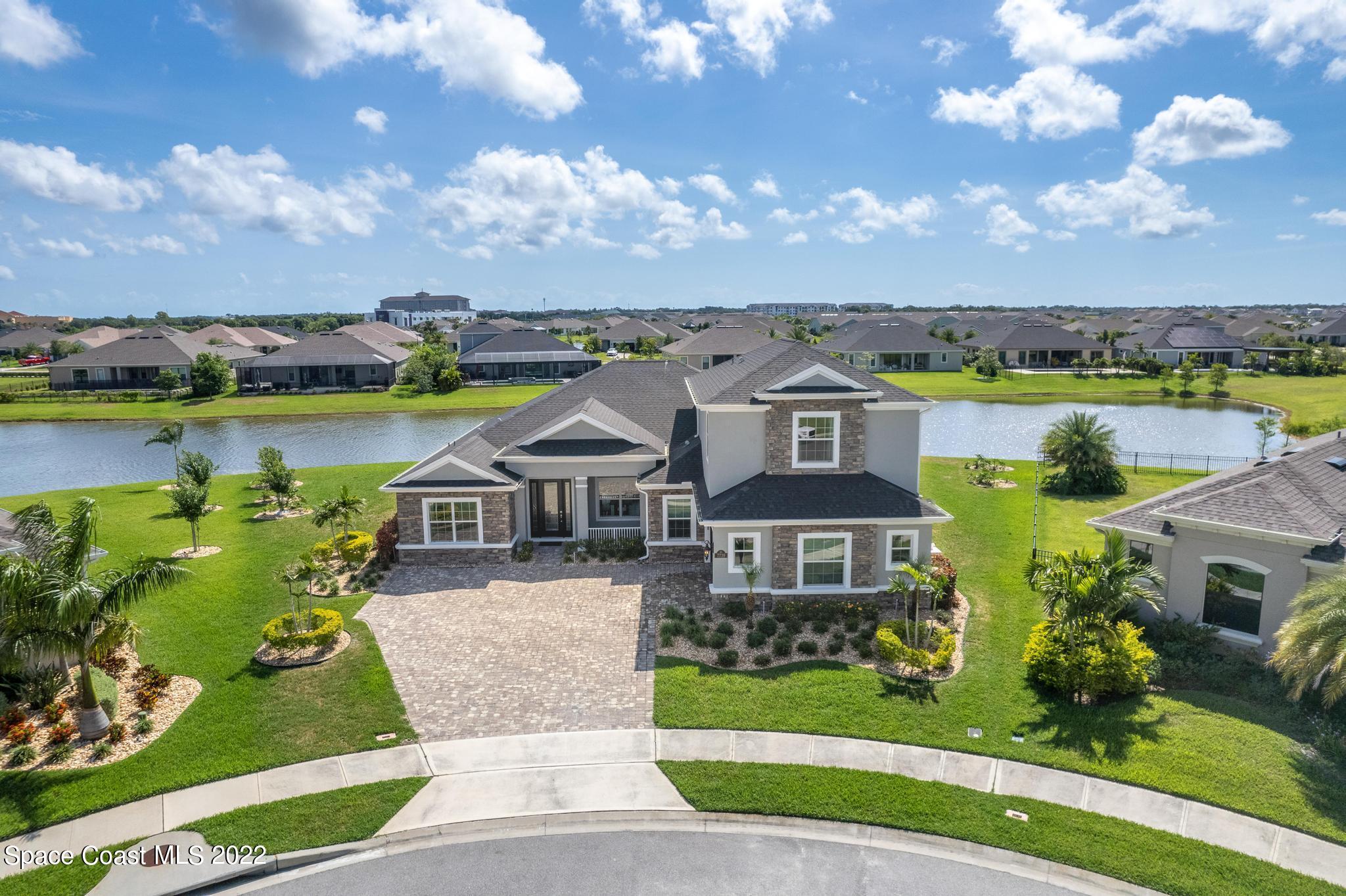 7739 Kerrington Drive Melbourne, FL 32940 - Photo 2 of 35 an aerial view of a house with a garden and lake view