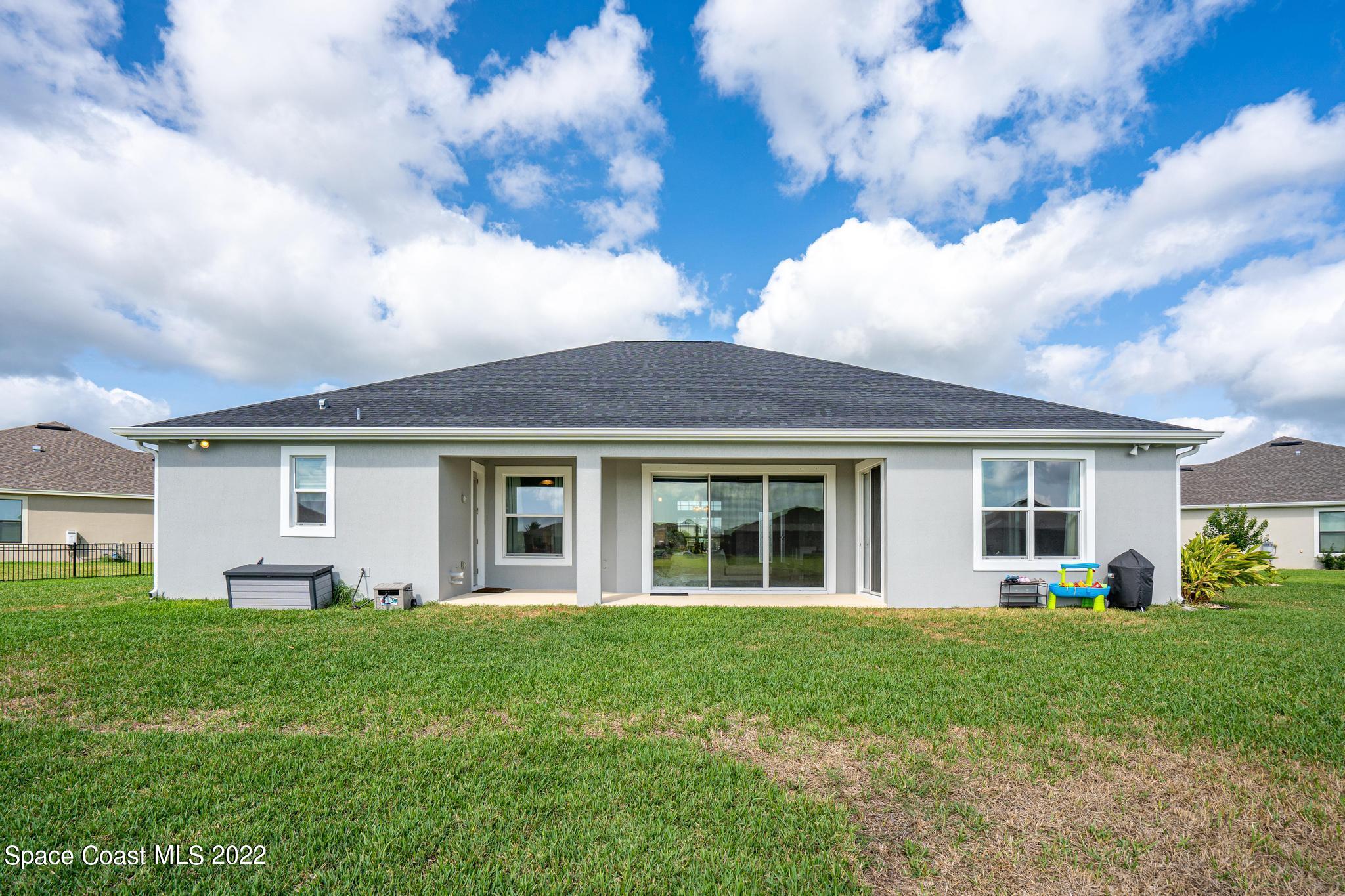 7739 Kerrington Drive Melbourne, FL 32940 - Photo 22 of 35 a front view of house with yard and green space