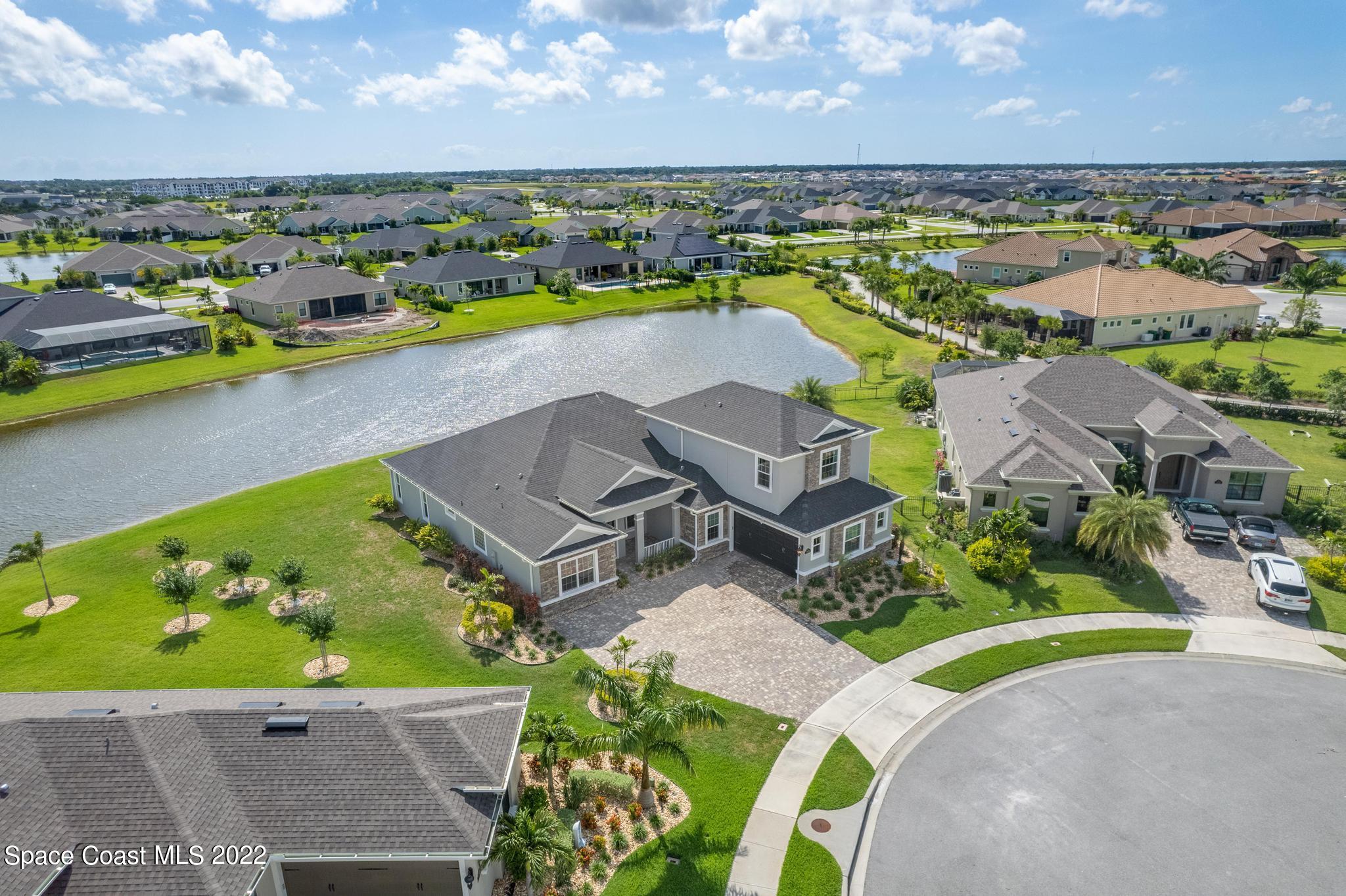 7739 Kerrington Drive Melbourne, FL 32940 - Photo 25 of 35 an aerial view of a house with a swimming pool yard and outdoor seating