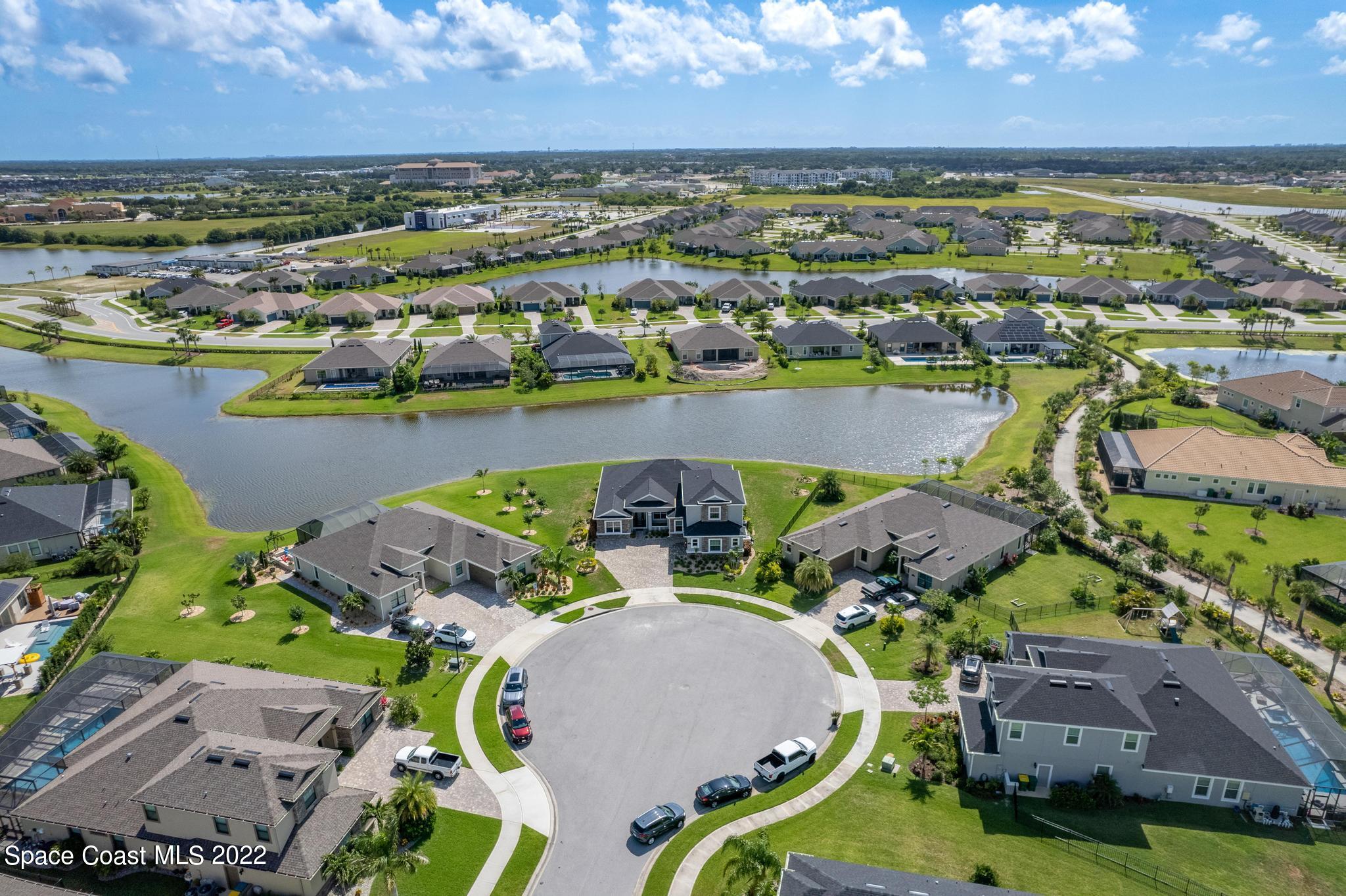 7739 Kerrington Drive Melbourne, FL 32940 - Photo 26 of 35 an aerial view of residential houses with outdoor space and lake view