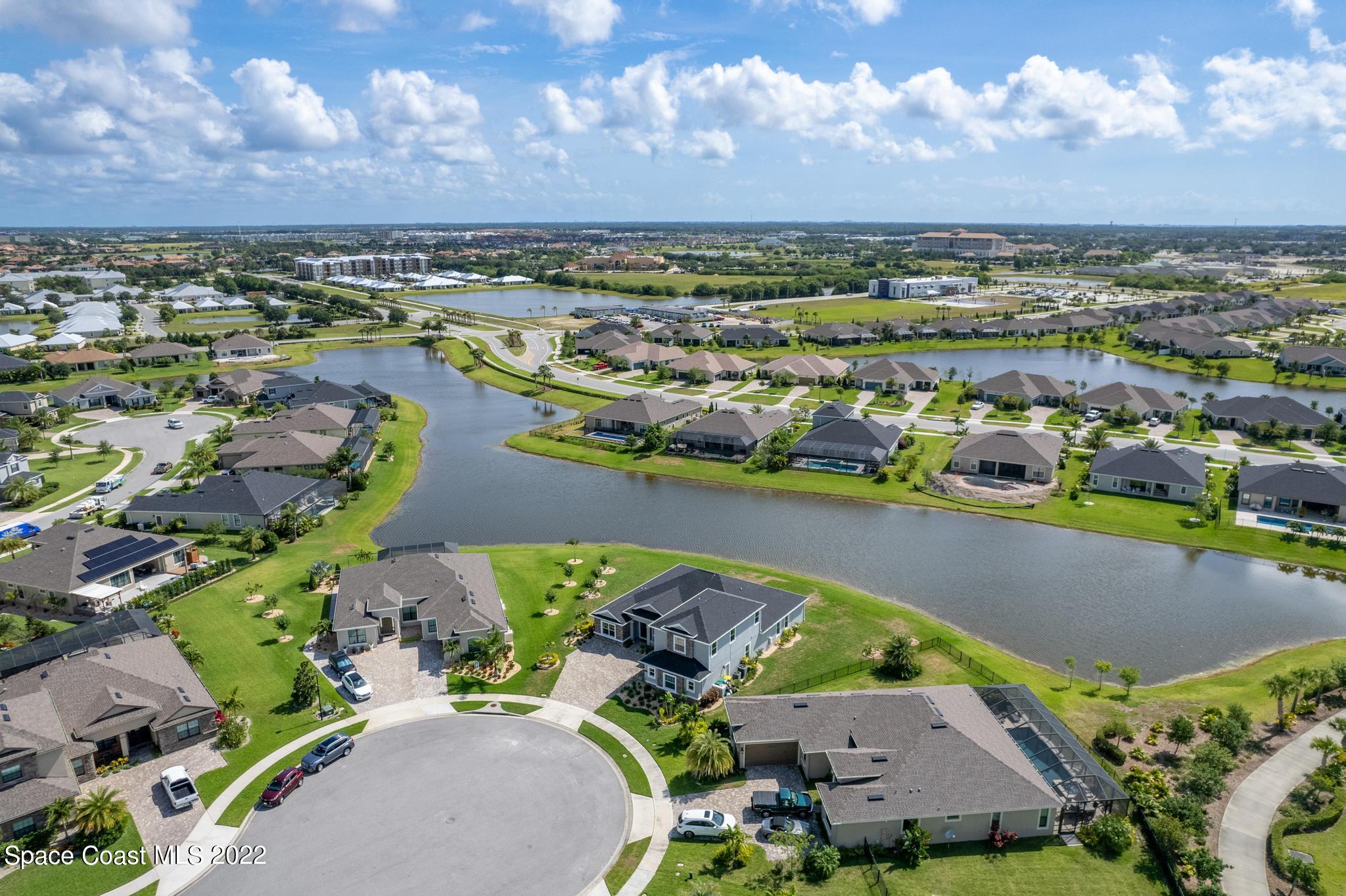 7739 Kerrington Drive Melbourne, FL 32940 - Photo 27 of 35 an aerial view of a house with a swimming pool yard and outdoor seating