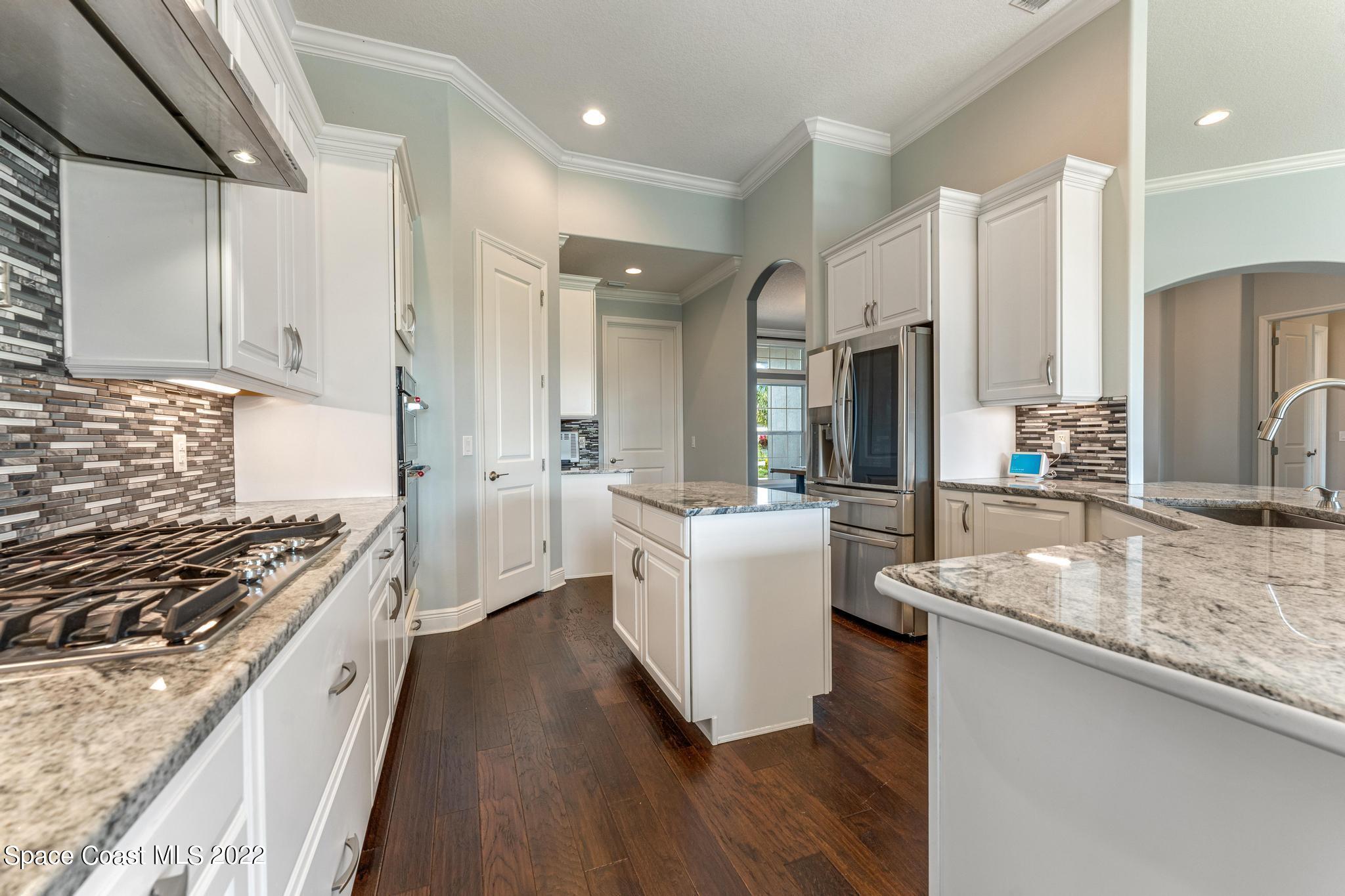 7739 Kerrington Drive Melbourne, FL 32940 - Photo 5 of 35 a kitchen with sink stove and refrigerator