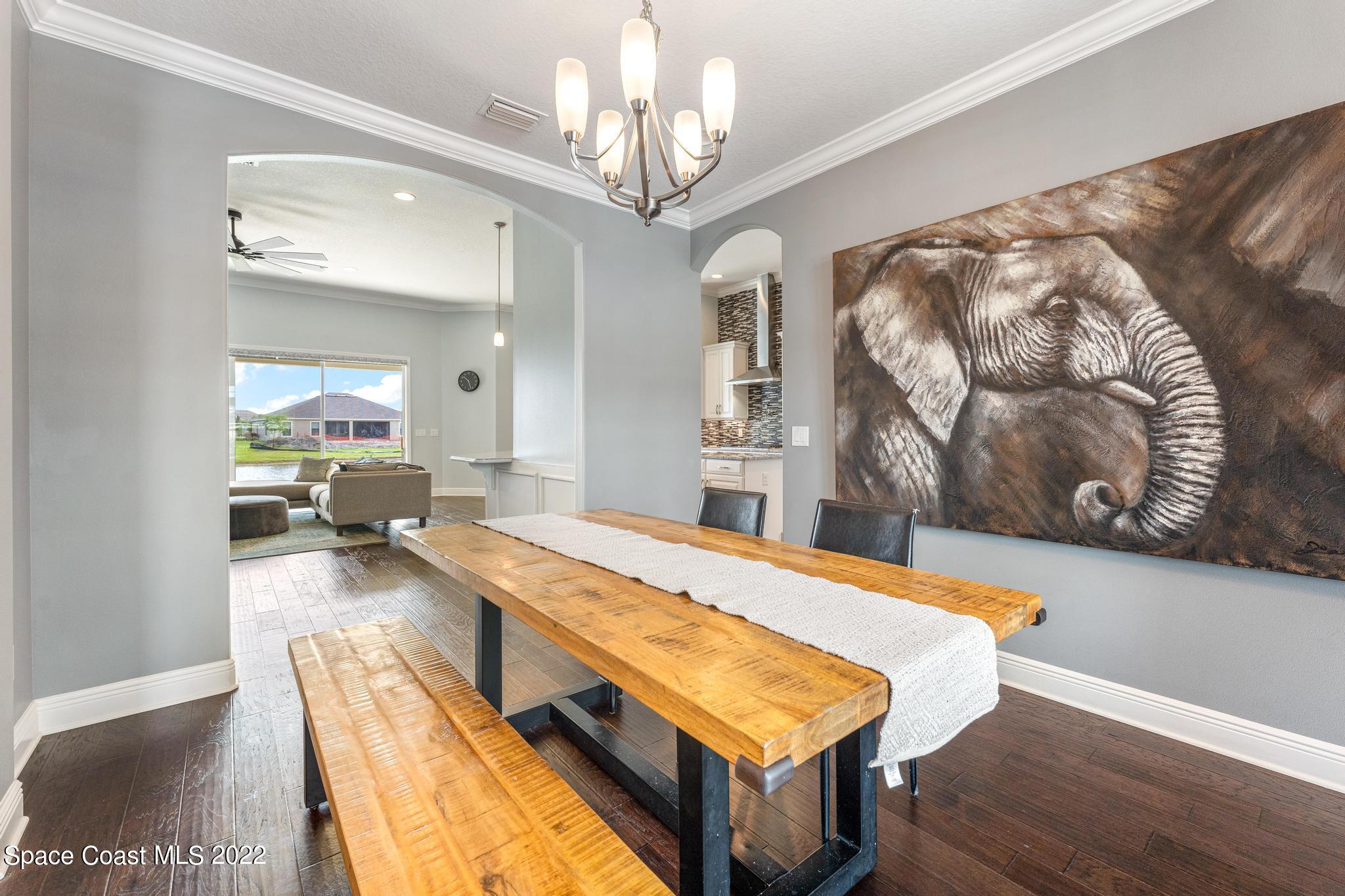 7739 Kerrington Drive Melbourne, FL 32940 - Photo 7 of 35 a living room with a bed furniture and kitchen view