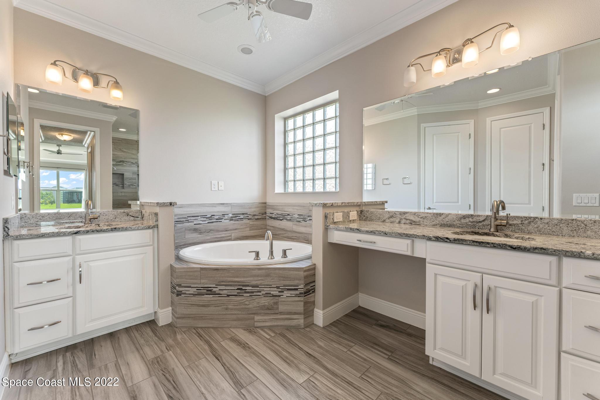 7739 Kerrington Drive Melbourne, FL 32940 - Photo 9 of 35 a bathroom with a granite countertop sink and a large mirror