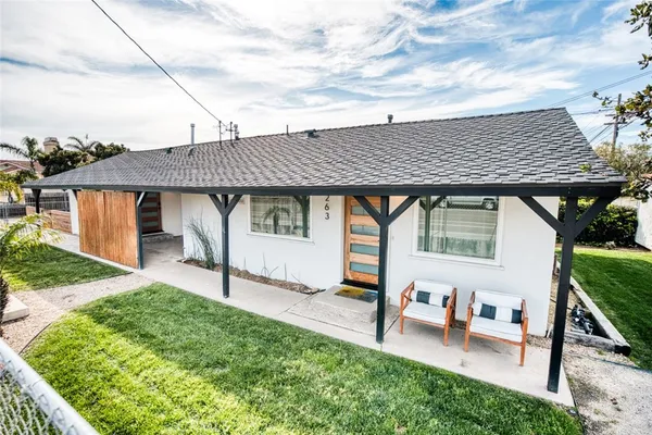 a backyard of a house with table and chairs