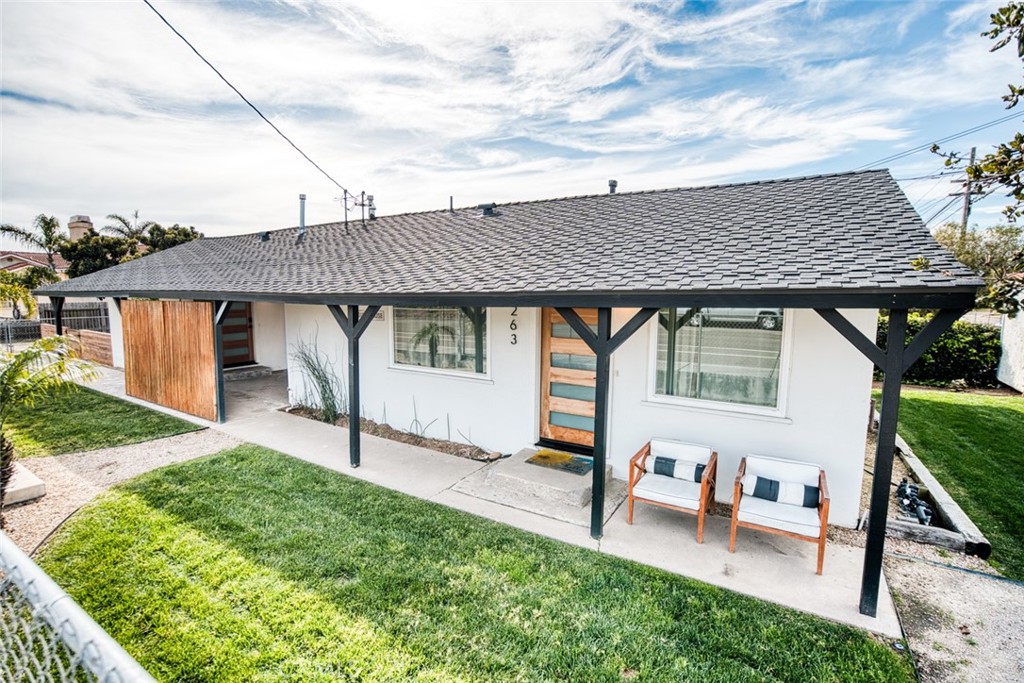 a backyard of a house with table and chairs