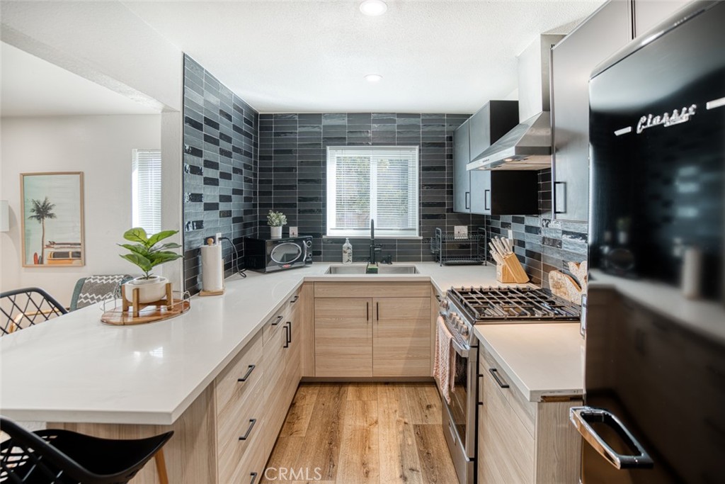 261 North 13th Street Grover Beach, CA 93433 - Photo 15 of 46 a kitchen with a sink stove and wooden floor