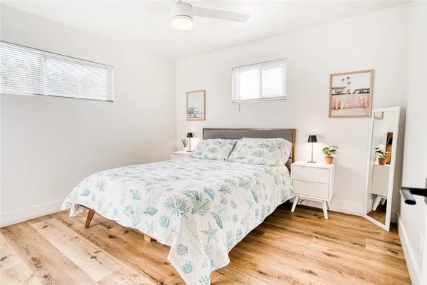 a bedroom with a bed and painting on the wall