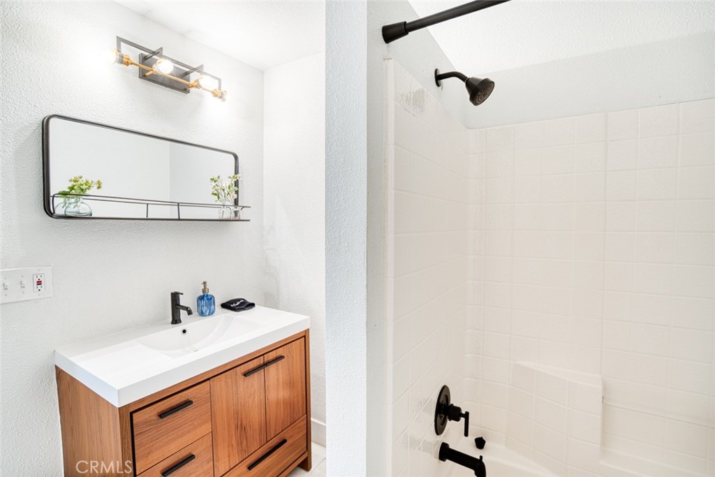 261 North 13th Street Grover Beach, CA 93433 - Photo 28 of 46 a bathroom with a sink vanity and mirror
