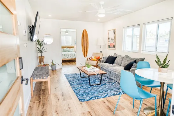 a living room with furniture fireplace and a large window