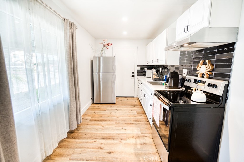 261 North 13th Street Grover Beach, CA 93433 - Photo 30 of 46 a kitchen with stainless steel appliances granite countertop a refrigerator a sink and a stove