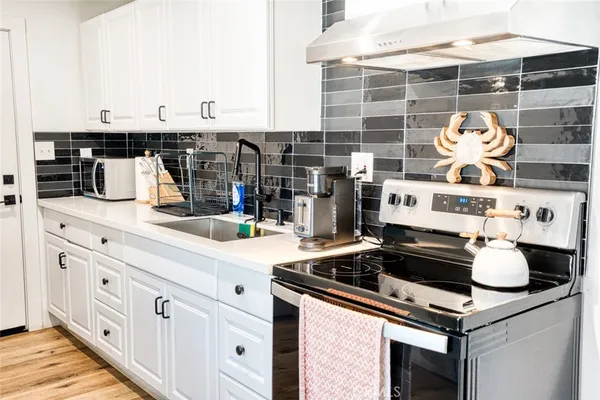 a kitchen with stainless steel appliances granite countertop a sink and cabinets