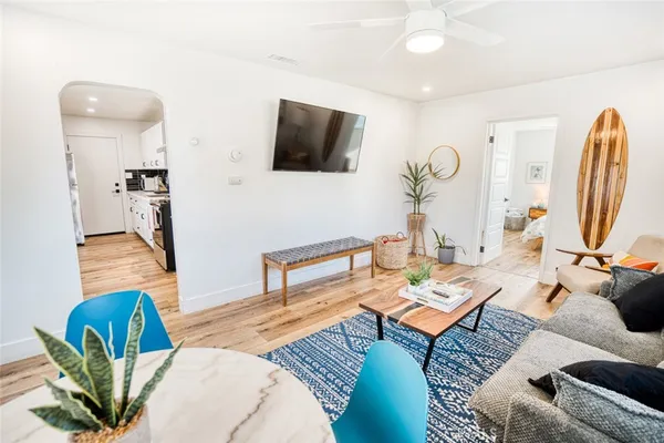 a living room with furniture a rug and a flat screen tv