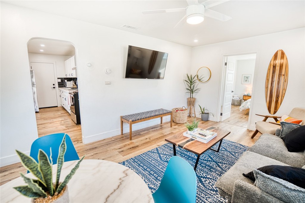 261 North 13th Street Grover Beach, CA 93433 - Photo 33 of 46 a living room with furniture a rug and a flat screen tv