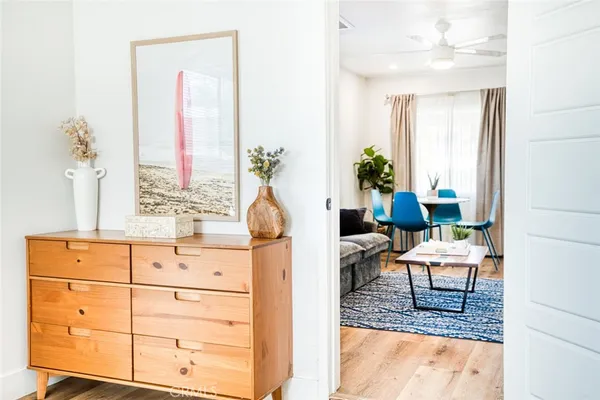 a living room with furniture and wooden floor