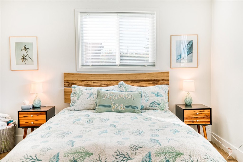 261 North 13th Street Grover Beach, CA 93433 - Photo 39 of 46 a bedroom with a bed and wooden floor