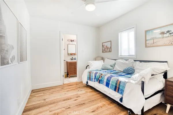 a bedroom with a bed and painting on the wall
