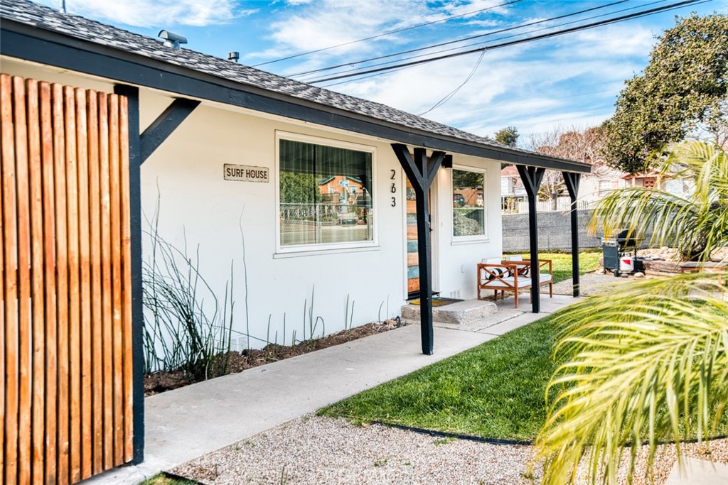 261 North 13th Street Grover Beach, CA 93433 - Photo 4 of 46 a front view of a house with a garden