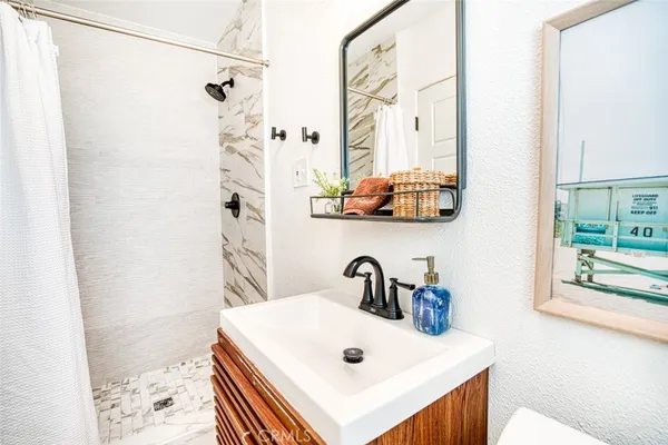 a bathroom with a sink a mirror and shower curtain