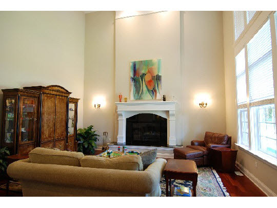 12737 Ashfield Road Caledonia, IL 61011 - Photo 6 of 11 a living room with furniture a fireplace and a large window