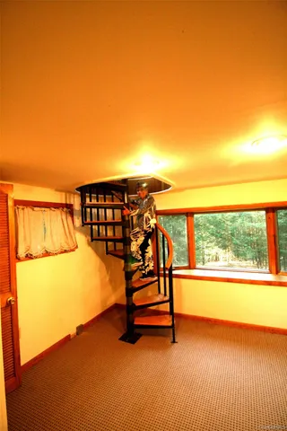 a view of a room with wooden floor and windows