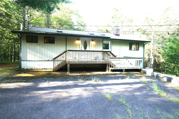 a view of a house with a yard and sitting area